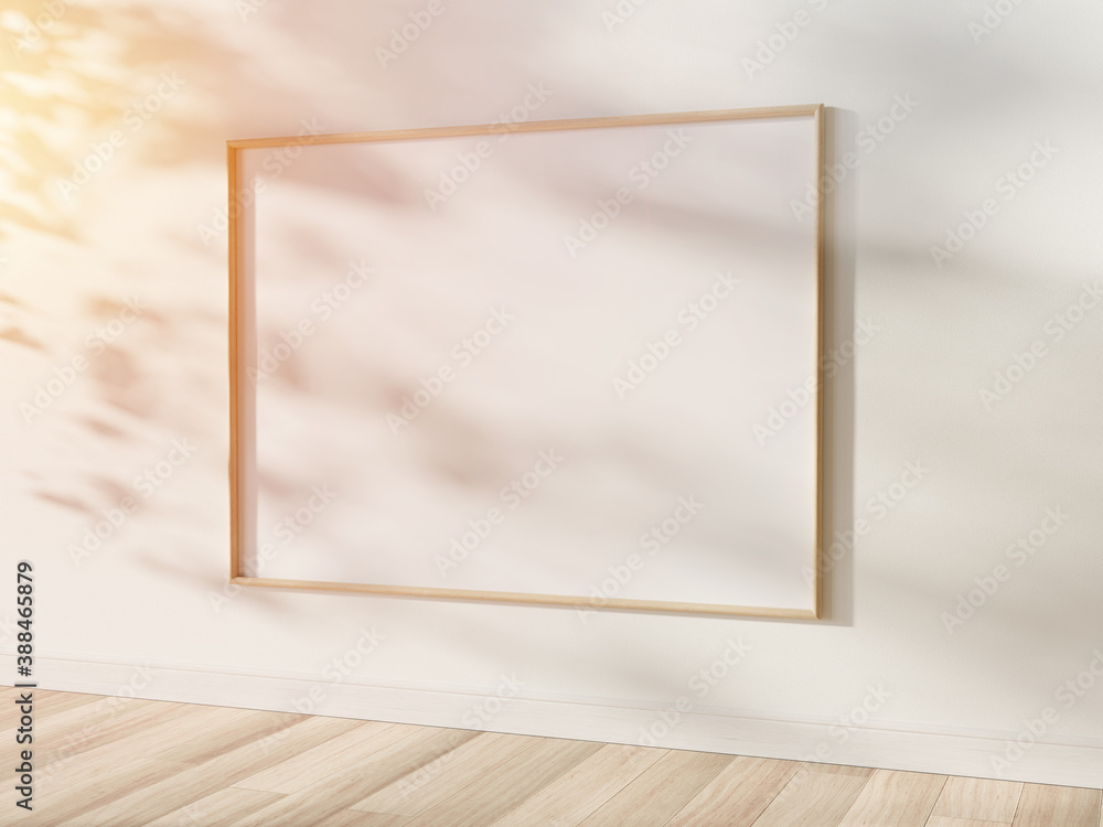 Fototapeta premium Wooden frame hanging in bright interior mockup. Template of a picture framed on a wall 3D rendering