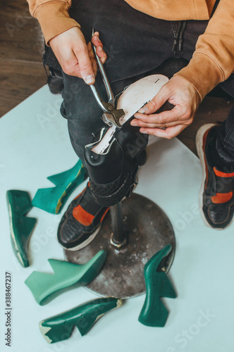 Close up of shoemaker making shoe using shoemaker tools