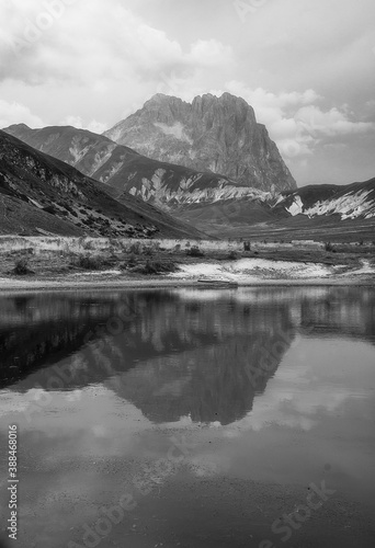 view of lake in Abruzzo with Gran Sasso mountain in background in black and white
