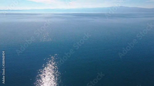 Wallpaper Mural Reflection of the sun on a pristine blue water of a natural lake. Beautiful colorful landscape drone shot. Torontodigital.ca