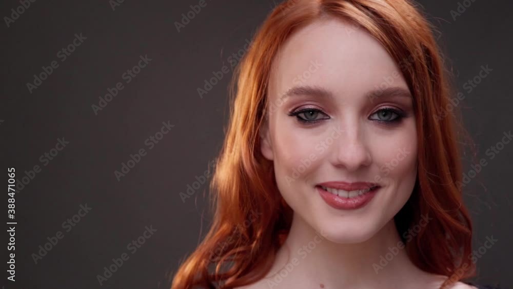 Red-haired woman 25-30 years old face close-up. Smile with teeth. Advertising of skin care products. Expression wrinkles. Shots under the eyes. Aging makeup. Red-haired woman 25-30 years old face close-up. Smile with teeth. Advertising of skin care products. Expression wrinkles. Shots under the eyes. Aging makeup.