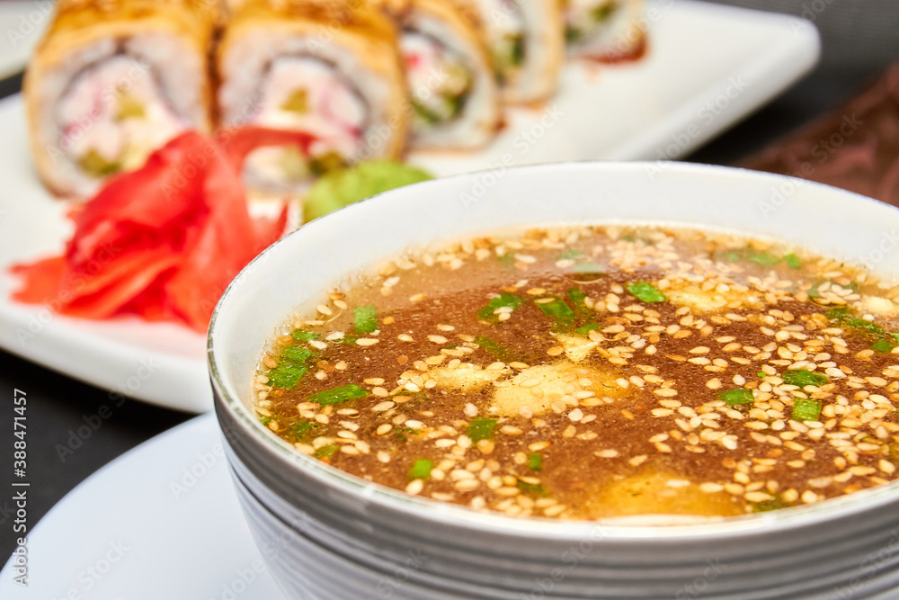 Japanese Miso soup and sushi rolls on the background Japanese Miso soup and sushi rolls on the background