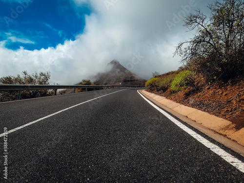 Long asphalt road ground view and travel concept - mountain and sky landscape - outdoor road trip in scenic place background © simona