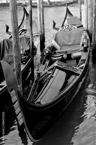 Venice, Italy, December 28, 2018 evocative black and white image of typical gondolas moored in Venice