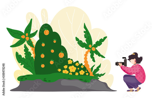 Young girl or woman and her hobby or daily activity - photographing nature and landscapes, walking with a camera. Tourist female character shooting landscape view green tropical plants and flowers