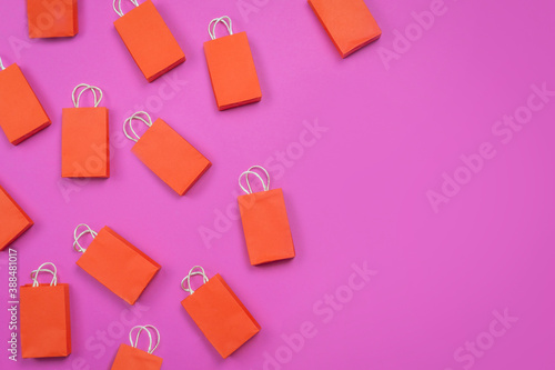 online shopping concept. many red shopping bags on pink background. concept of shopping . copy space.