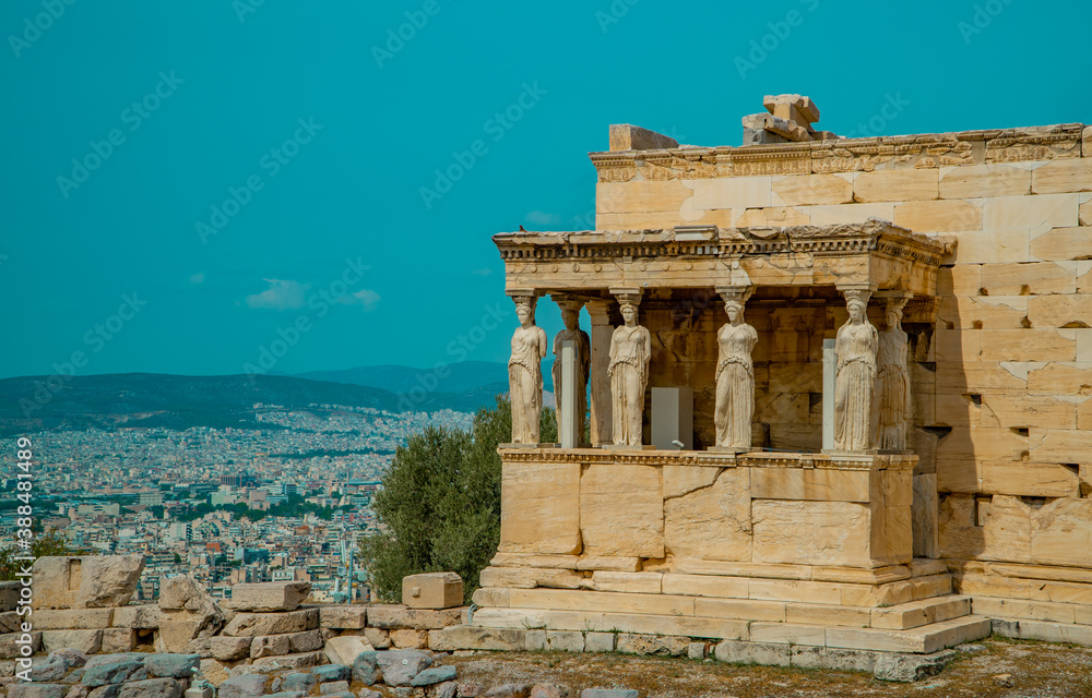 Caryatides, Erechtheion Temple at Athens Acropolis with a city view of Athens, Greece in the background