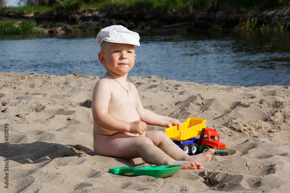 child playing on the beach by the water child playing on the beach by the water