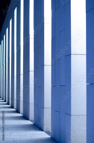 Abstract architectural wall with columns in modern style with shadow. Building with a perspective view in blue