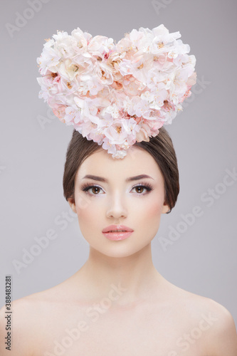 Front beauty portrait. Beautiful girl with spring flowers and bare shoulders. Creative Make up and Hair Style. © Dragosh
