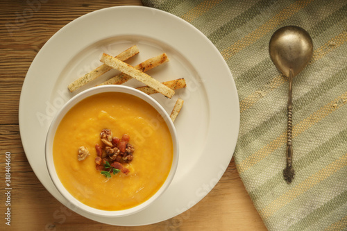 homemade creamy pumpkin soup with nuts and bacon