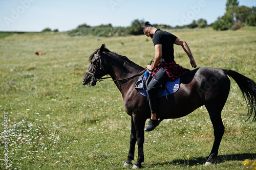 Arab tall beard man wear in black ride arabian horse. © AS Photo Family