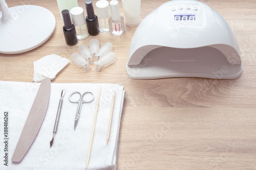 Nail work place White lamp on white table with nail tool . Work place of nail amster with manicure tools.