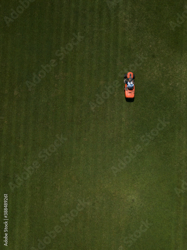 Vászonkép Aerial top down view of man mowing grass on football stadium