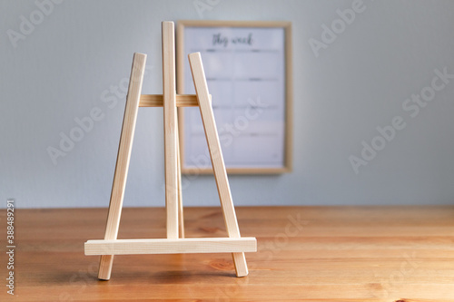 wooden easel on empty interior background
