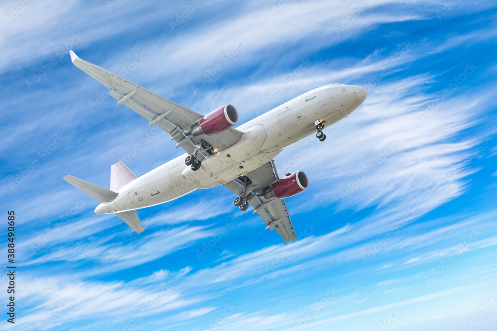 Commercial airplane flying above blue sky and white clouds. Commercial airplane flying above blue sky and white clouds.