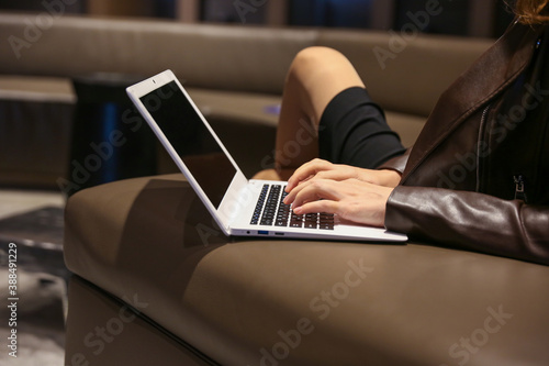 blogger's hands are typing on laptop in the waiting room