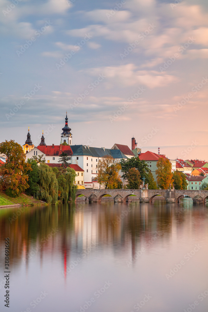 Pisek, Czech Republic. Cityscape image of Pisek with famous Stone Bridge at beautiful autumn sunset.
