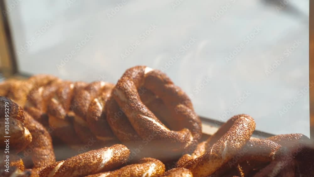 Hand of a man picking a turkish bagel simit Hand of a man picking a turkish bagel simit
