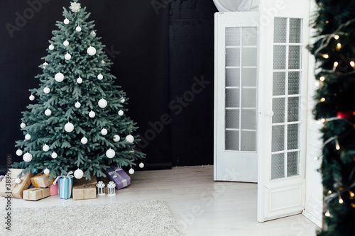 Christmas tree pine with gifts new year decor black background © dmitriisimakov