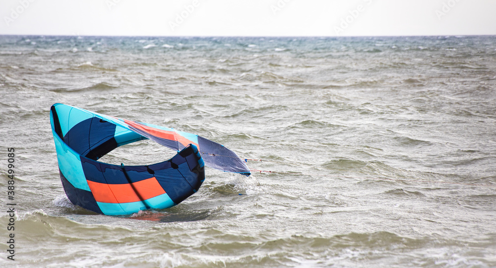 Lift kite from the water. Blue parachute from kite surfing fell in the sea. Copy space. Common Beginner Mistakes