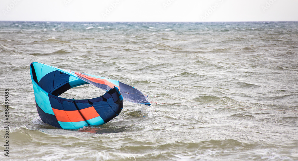 Lift kite from the water. Blue parachute from kite surfing fell in the sea. Copy space. Common Beginner Mistakes Lift kite from the water. Blue parachute from kite surfing fell in the sea. Copy space. Common Beginner Mistakes