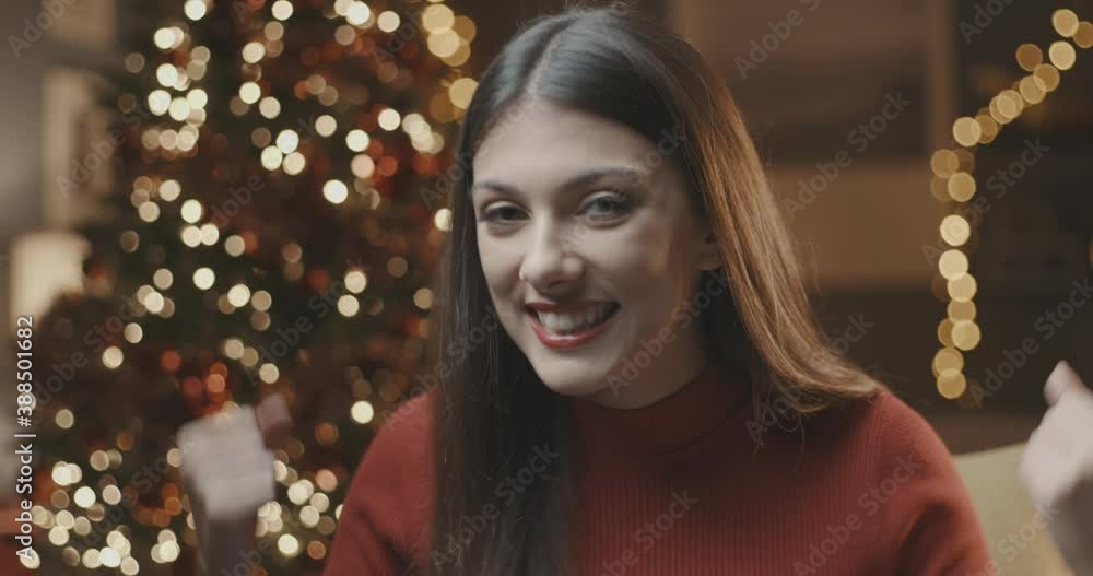 Happy woman showing a calendar on Christmas day Happy woman showing a calendar on Christmas day