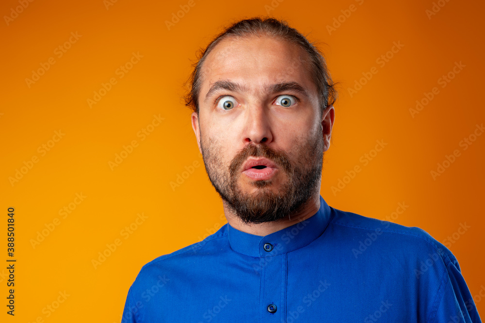 Amazed and confused bearded man looks with astonishment Amazed and confused bearded man looks with astonishment