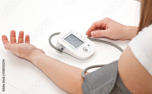 Woman measures blood pressure at home