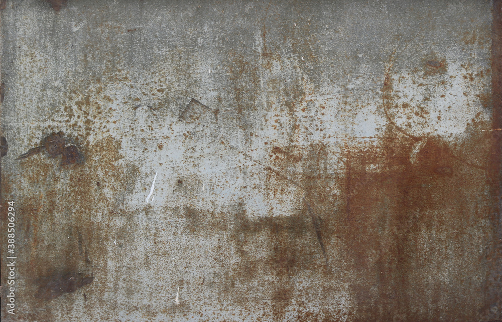 rusty metal surface with gray and light brown tones - worn steampunk background with scratches and grooves