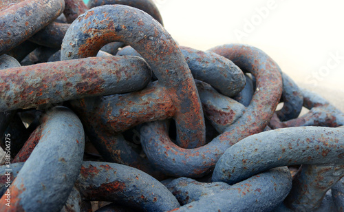 rusty chains with thick links, isolated over a white background - steampunk heavy wallpaper © Domingo