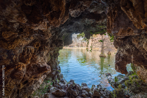 Small lake in Buen Retiro park seen through a cave