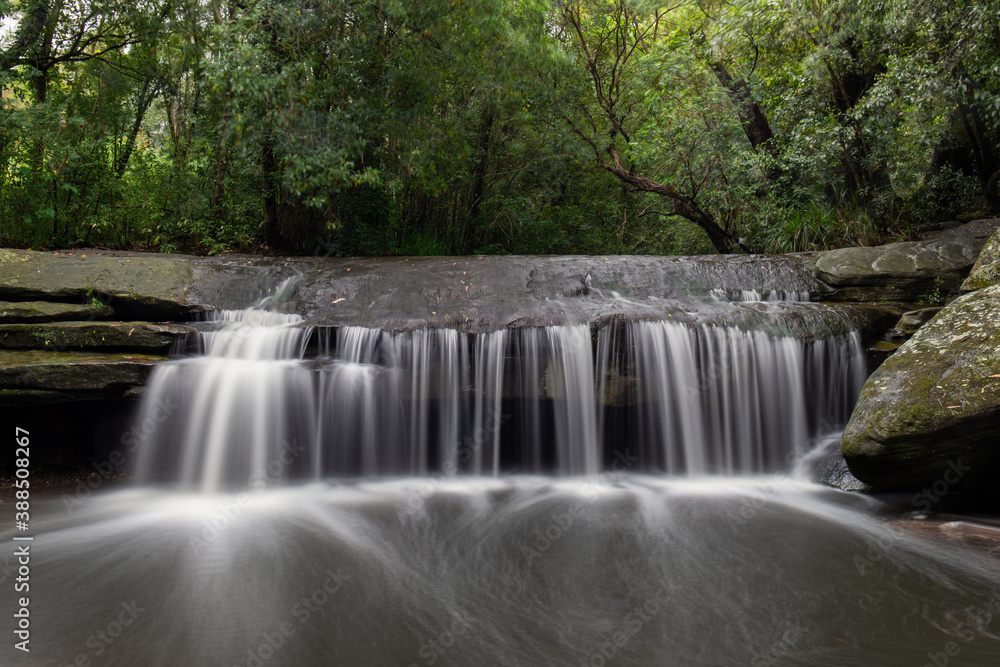 Strong water flow at Terry's Creek waterfall, Sydney after rain. Strong water flow at Terry's Creek waterfall, Sydney after rain.