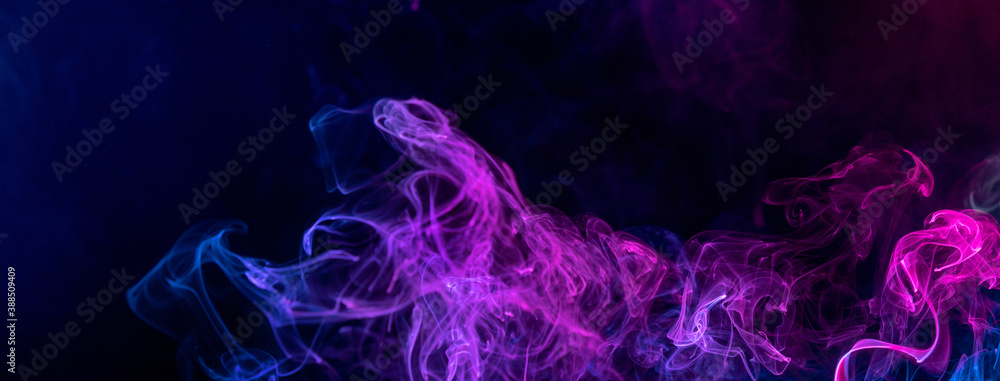 Fototapeta premium Conceptual image of colorful red and blue color smoke on dark black background.