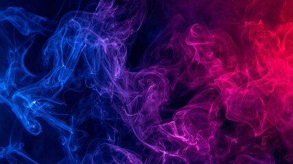 Conceptual image of colorful red and blue color smoke on dark black background.