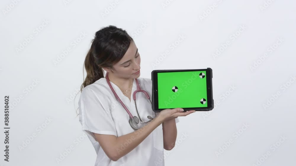 Medical professional hold up tablet and smiling with green screen for keying. Medical professional hold up tablet and smiling with green screen for keying.