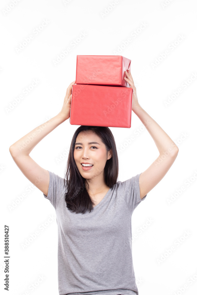 Happy pretty young woman holding gift box present in christmas or new year on white background. Happy pretty young woman holding gift box present in christmas or new year on white background.