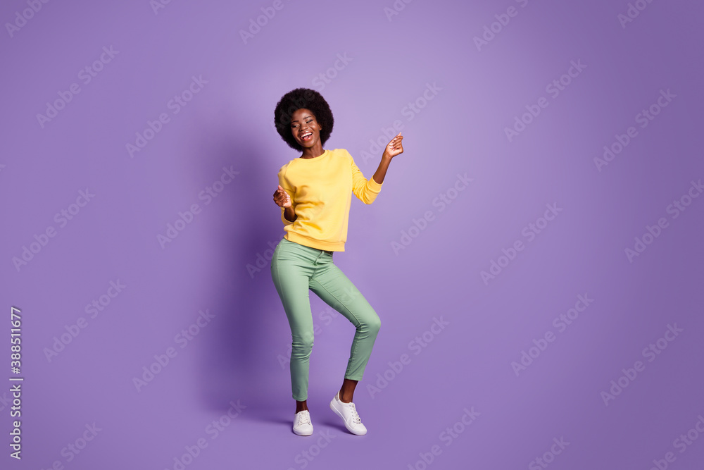Full length photo of lovely girl look empty space dancing wear yellow pullover isolated violet color background