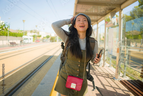 фотографія outdoors portrait of young happy and beautiful Asian Korean tourist woman with b