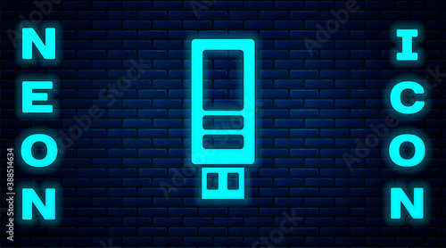 Glowing neon USB flash drive icon isolated on brick wall background. Vector.