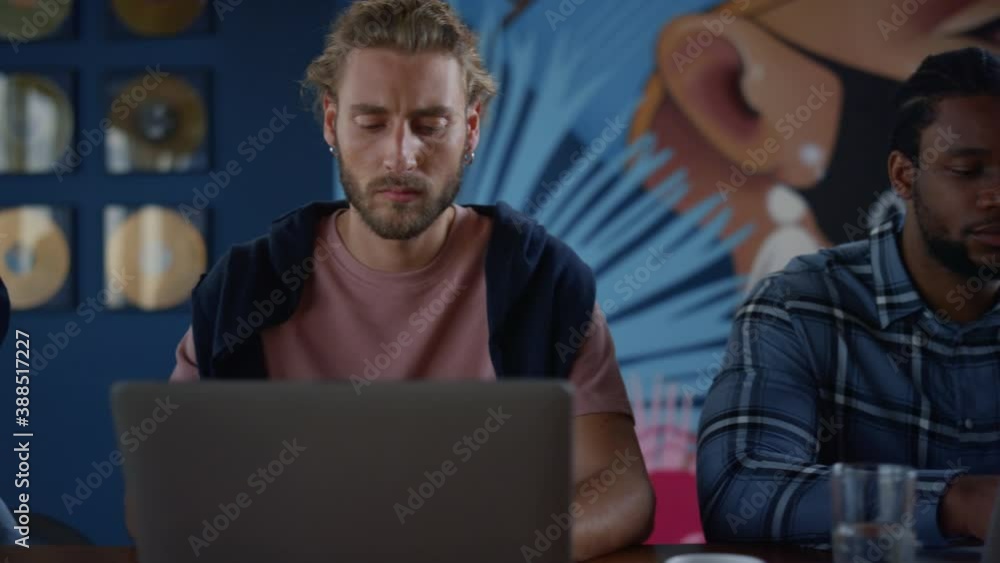 Closeup multiracial business people working remote on laptops in open space