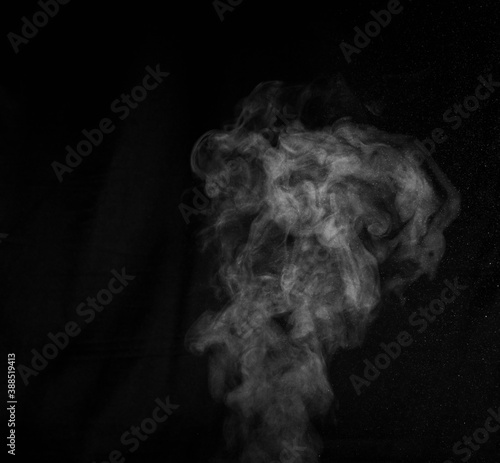 White smoke on black background. Abstract background, design element, for overlay on pictures © Alena