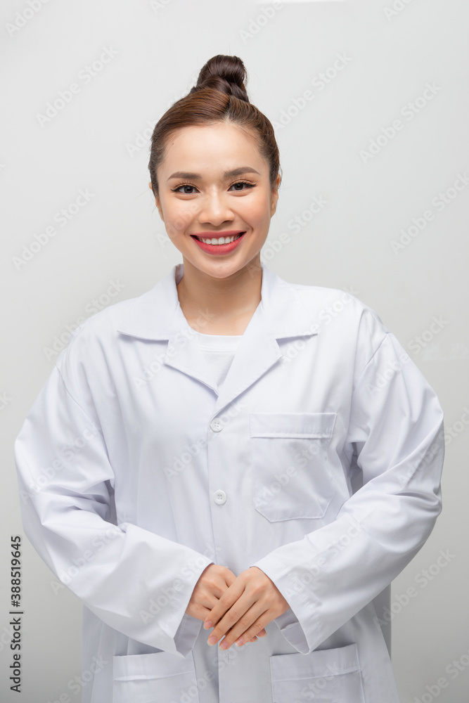 Young asian doctor woman wearing coat standing over isolated white background with a happy and cool smile on face Young asian doctor woman wearing coat standing over isolated white background with a happy and cool smile on face