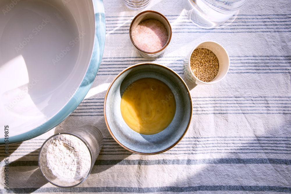 Ingredients on the table, view from above. Preparing dough in bowl for homemade bread or pancakes. Recipe to make at home. Honey, salt, flour, water. Ingredients on the table, view from above. Preparing dough in bowl for homemade bread or pancakes. Recipe to make at home. Honey, salt, flour, water.
