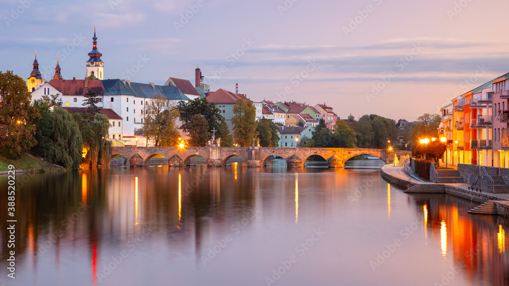 Pisek, Czech Republic. Panoramic cityscape image of Pisek with famous Stone Bridge at beautiful autumn sunset.