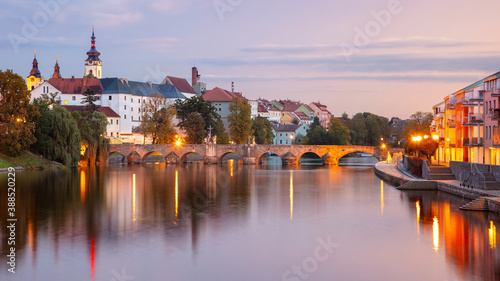 Pisek, Czech Republic. Panoramic cityscape image of Pisek with famous Stone Bridge at beautiful autumn sunset.