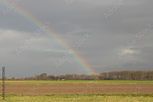 Rainbow in a flatland landscape in the autumn