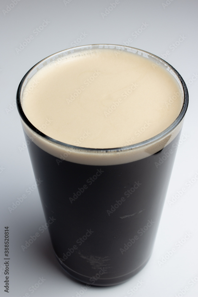 Glass of dark beer on white background Glass of dark beer on white background