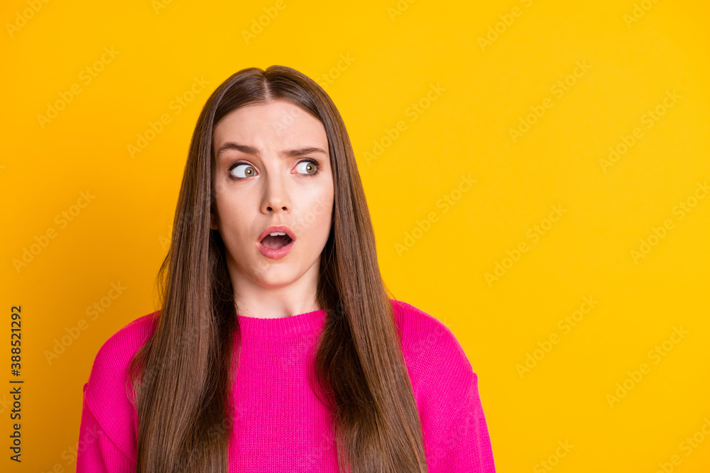 Photo of cute scared girl open mouth look empty space wear pink pullover isolated yellow color background Photo of cute scared girl open mouth look empty space wear pink pullover isolated yellow color background