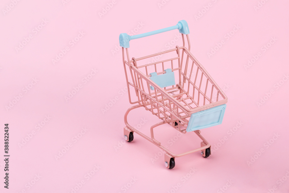 Lovely pink shopping cart on pink background, empty shopping cart, shopping concept, online shopping Lovely pink shopping cart on pink background, empty shopping cart, shopping concept, online shopping